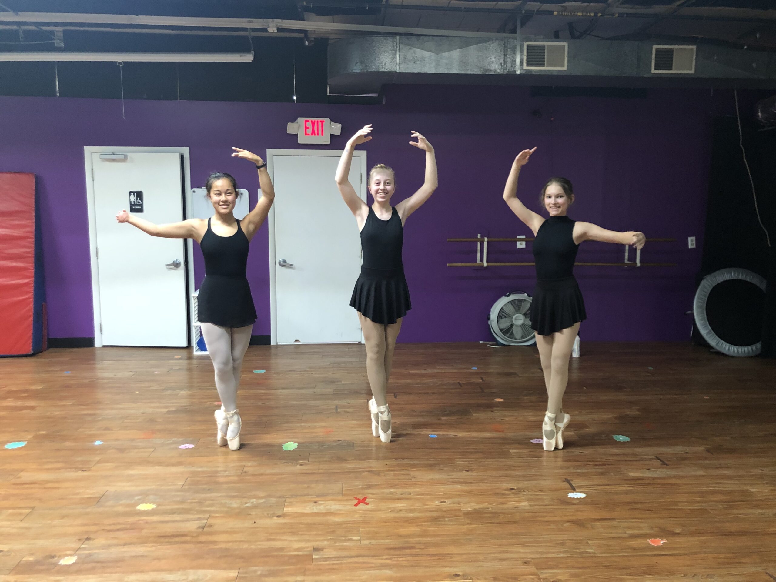 3 dancers standing on pointe in dress code